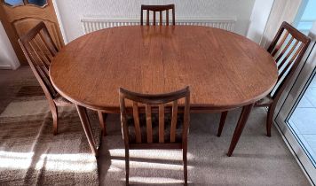 A mid 20thC G plan teak extending dining table and four chairs. Size extended 208cm l x 112cm w x