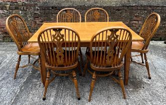 A good quality oak table and set of six windsor style dining chairs with crinoline stretchers. Table