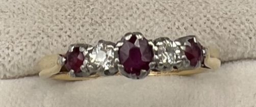 An 18 carat and platinum ring set with diamonds and rubies. Size J/K. Weight 2.3gm.