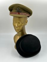 British WWII Royal Artillery officers visor cap with badge together with a vintage Moss Bros