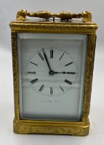 A 19thC brass cased carriage clock by Berrolla Paris. White enamel dial. Striking on a bell and