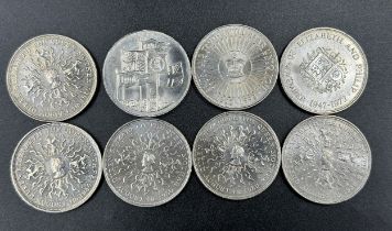 A collection of eight 5 pound coins.
