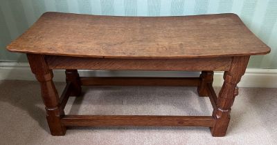 A 1960's Robert Thompson Mouseman oak seat, curved rectangular top with adzed decoration, four
