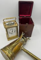 A brass cased carriage clock with French movement in original leather covered carrying case with key