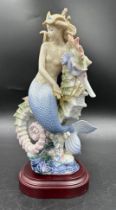 A Lladro figurine "Beneath the Waves ' 1822 on wooden plinth, boxed, a limited edition 1939 of