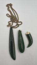Three jade pendants, one with a 9 carat gold chain, length 60cm, weight approximately 12gm, one with