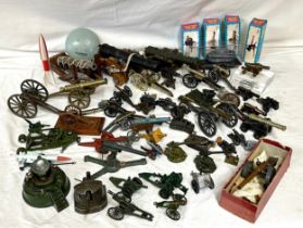 An assortment of miniature canons and military accessories to include Britains, Dinky, Depose and