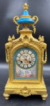 A 19thC French gilt metal and porcelain mantle clock, striking on a bell. 42cm h. Marked to works
