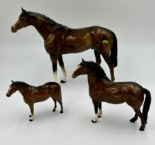 Three Beswick bay horses to include large horse 28cm h. Two smaller horses with stamps underneath,