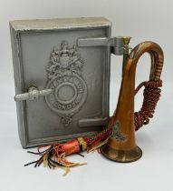 A British Army Royal Artillery brass and copper bugle with yellow, black and red cord tassel and