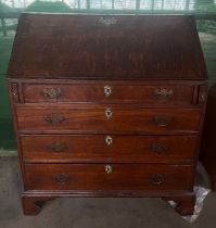 An 18thC oak bureau with four graduated drawers and bracket feet with fitted interior. 92cm x