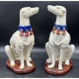 A pair of large ceramic greyhounds in seated position. 35cm h.