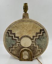 A large Troika Wheel lamp base with abstract relief designs to both sides, brown green and cream