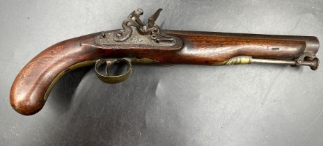 A flintlock pistol, overall length approx. 38cm with a round barrel, brass mounts, border and scroll