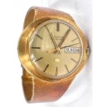 A gentleman's Bulova 'Accuquartz' wristwatch with day and date aperture, 18ct gold case and