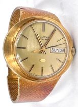 A gentleman's Bulova 'Accuquartz' wristwatch with day and date aperture, 18ct gold case and