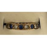 A diamond and sapphire eternity ring set in unmarked yellow metal. Size O/P. Weight 2.4gm.