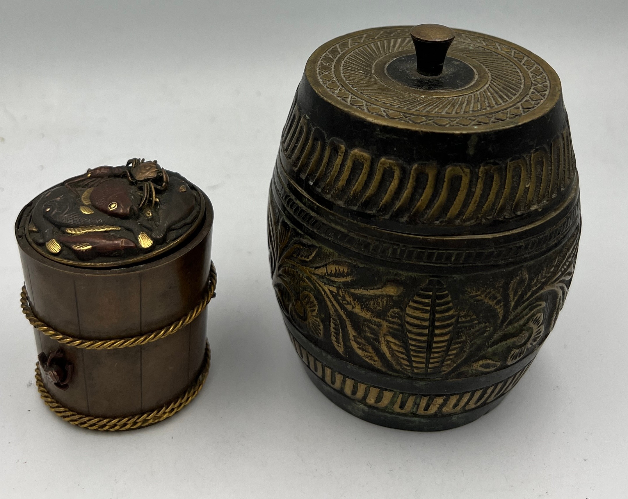 A Japanese brass and copper inkwell, 5.5cm h together with a brass lidded pot.