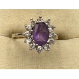 A 9 carat gold ring set with purple and clear stones. Size L, weight 2.2gm.