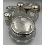 Four silver topped glass dressing table jars. Sheffield 2000, maker Carr’s of Sheffield Ltd and a