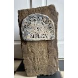 A piece of stone with sign depicting ' Beverley 5 miles'. 39cm h x 21cm w x 16cm d.