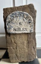 A piece of stone with sign depicting ' Beverley 5 miles'. 39cm h x 21cm w x 16cm d.