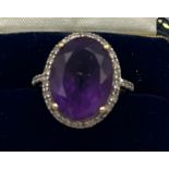 A 9 carat gold ring set with amethyst and white topaz. Size N. Weight 4.3gm.