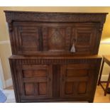 An oak court cupboard with carving to the top, MA 1698. 138cm w x 57cm d x 151cm h. Top shows