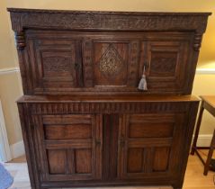 An oak court cupboard with carving to the top, MA 1698. 138cm w x 57cm d x 151cm h. Top shows