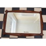 An early 20thC mahogany framed bevel edged wall mirror. 76cm x 51cm.