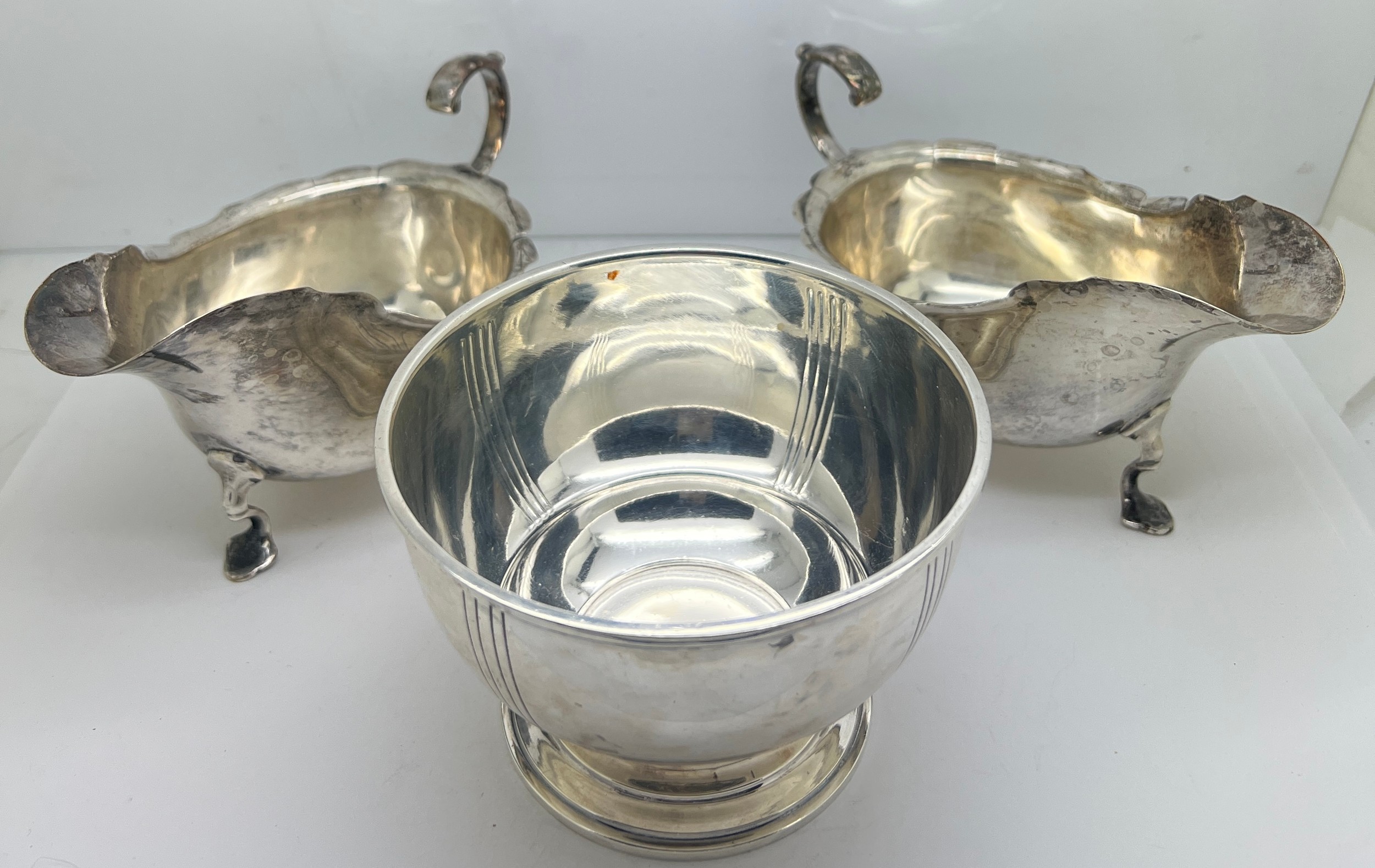 A pair of silver sauce boats, Sheffield 1907, maker Pearce & Sons and a sugar bowl, London 1935,