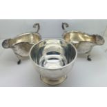 A pair of silver sauce boats, Sheffield 1907, maker Pearce & Sons and a sugar bowl, London 1935,