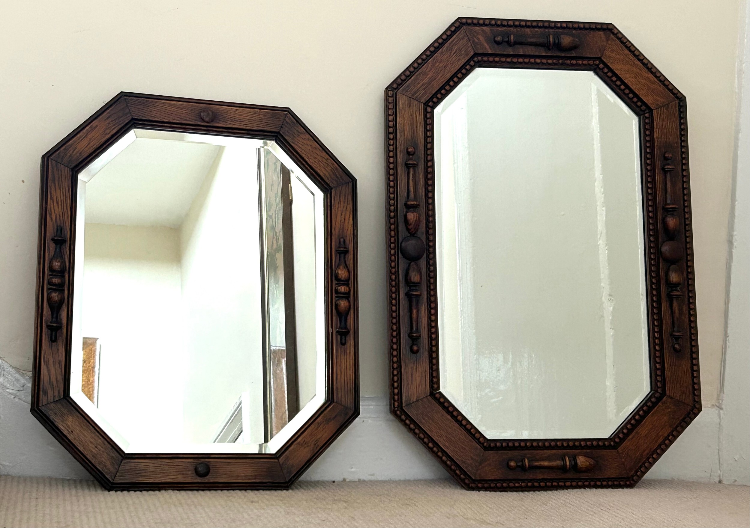 Two vintage oak wall mirrors with bevelled glass. Largest 70 x 46cm and smallest 54 x 44cm.