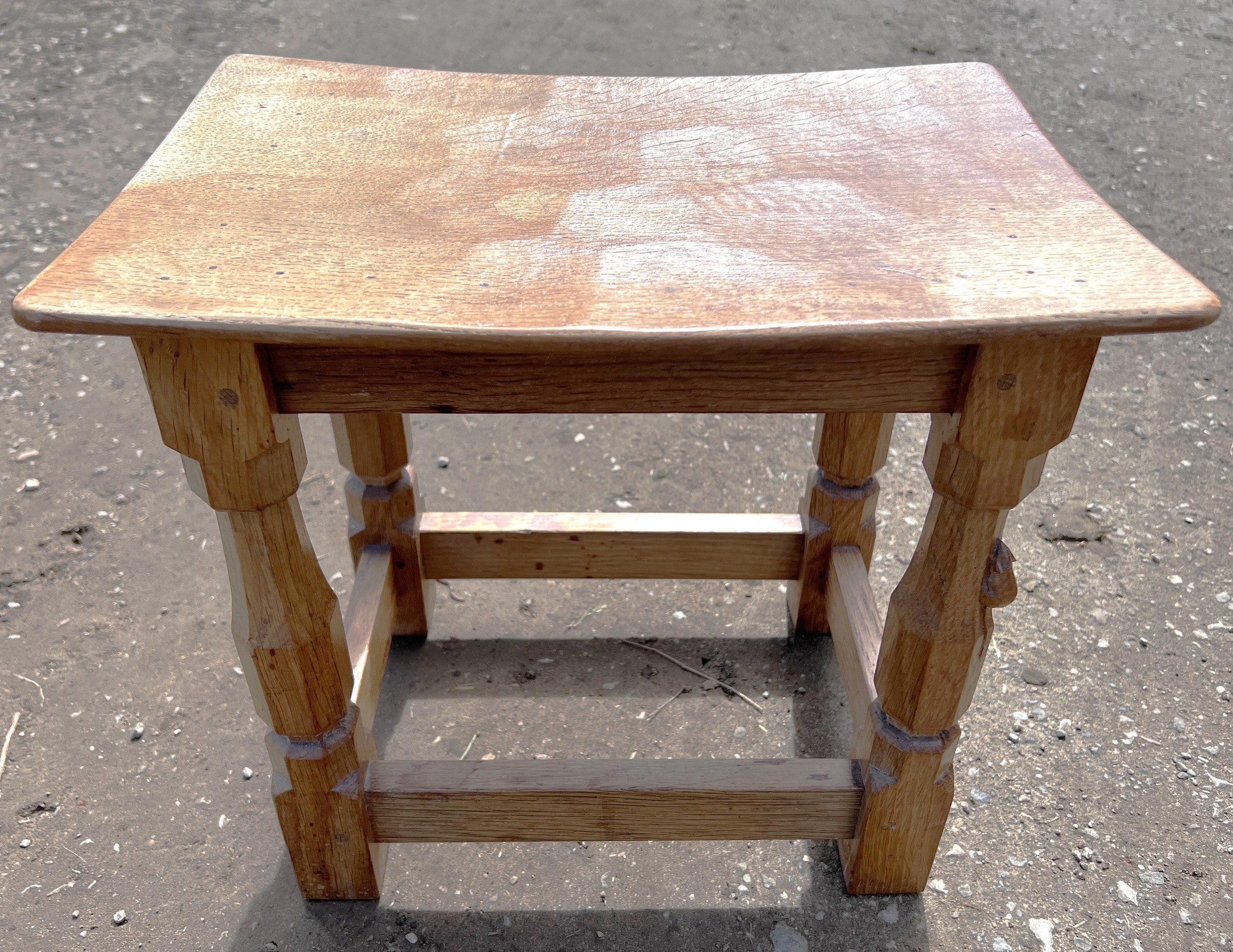 An oak Robert 'Mouseman' Thompson stool with adzed top. 40cm w x 27.5cm d x 31cm h.