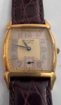 A Bulova two tone dial art deco quartz wristwatch on brown leather strap. In red box.