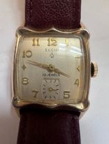 An art deco style 14ct rolled gold bezel Elgin wristwatch with subsidiary seconds dial on brown