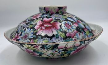 A Chinese porcelain famille rose bowl and cover, enamelled with millefleurs decoration and 6