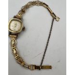 A vintage ladies Swissam wristwatch on a 9 carat gold bracelet. Total weight 14.1gm.