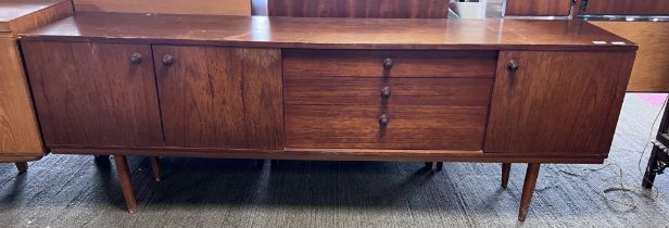 A mid 20thC long sideboard, three cupboards and three drawers. 203cm l x 43cm d x 77cm h.