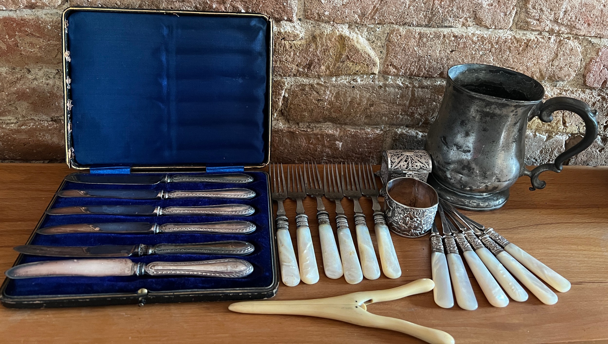 A miscellany to include 6 mother of pearl handled walnut picks, boxed silver handled dessert knives,