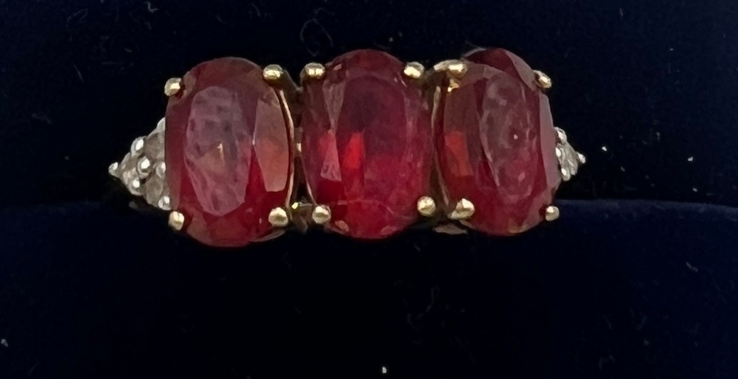 A 9 carat gold ring set with pink and clear stones. Size N. Weight 2.3gm.