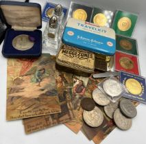 A miscellany to include vintage tins, coins, crowns, nickel silver York Minster medal, glass cruet
