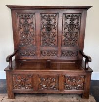 Carved Oak High Back Settle with lift up seat. 133cm wide x 46cm depth x 148cm high.