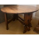 An oak drop leaf circular side table. 91cm x 77cm open x 50cm h. 30cm w when leaves down.
