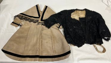Two Victorian items of clothing to include a child’s dress in brown with black velvet trim, lace