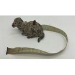 An early 20thC metal sheep tape measure. 5cm l. Measures centimetres and inches.