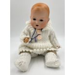 A German Armand Marseille Bisque headed Baby Doll (353/4) with knitted outer clothing and original