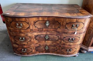 An 18thC Austrian parquetry inlaid serpentine fronted chest of three drawers with brass fittings, on