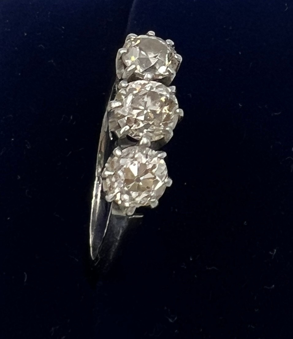 A three stone diamond ring mounted in platinum. Size K. Weight 3.5gm. Approximate diamond - Image 5 of 7