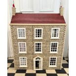A large 20thC doll's house opening to reveal decorated rooms over 3 stories. 74cm x 96cm h to